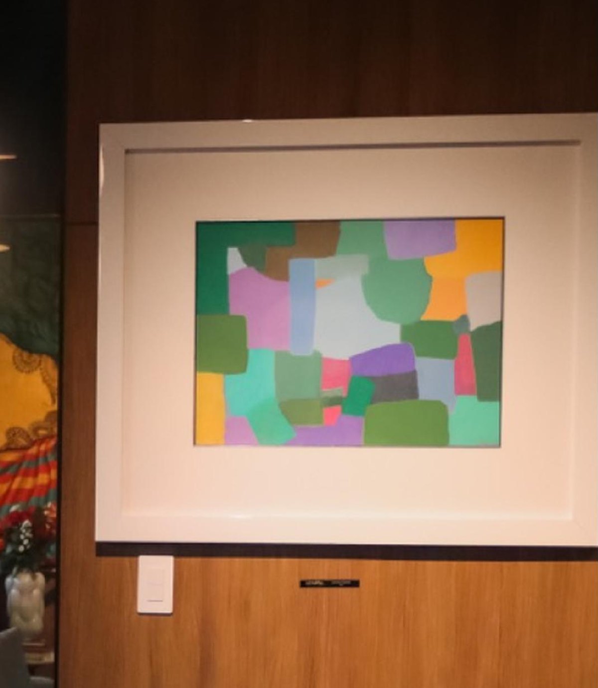 Federico Herrero's untitled painting above the reception sofa, against the ochre wall