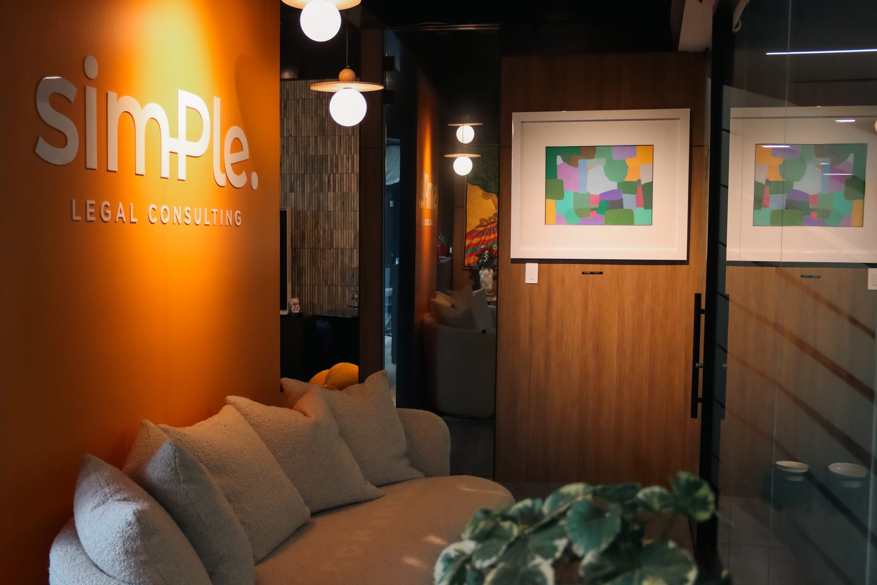 Reception, with the firm's wall and the waiting sofa